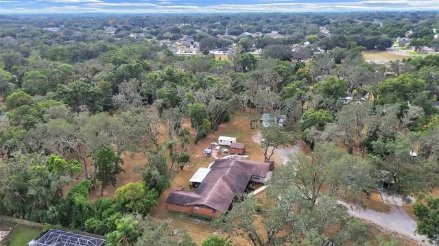 an aerial view of a house with a yard