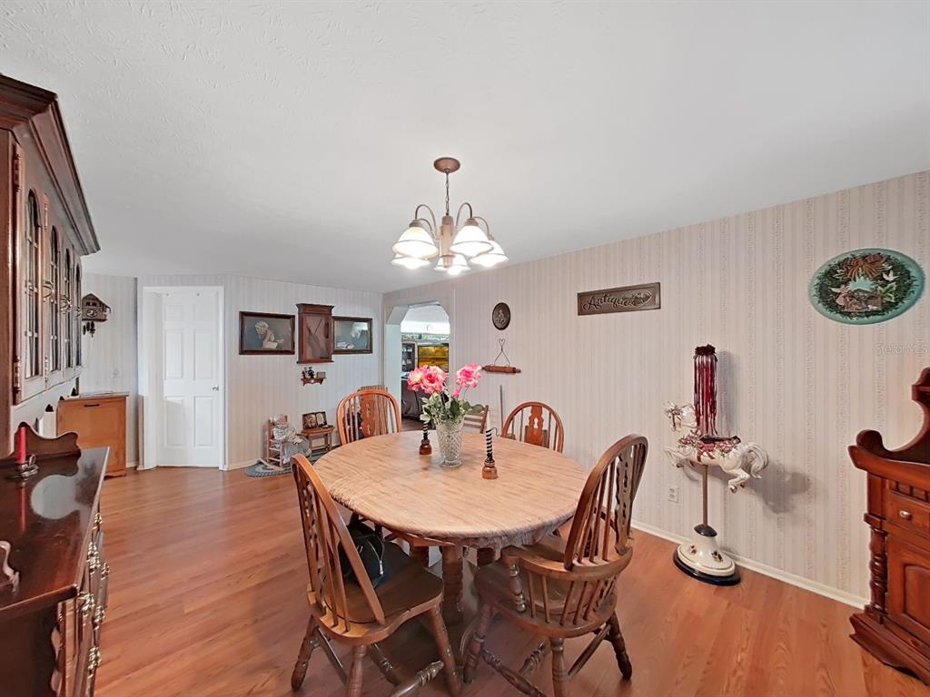 4105 Robinson Road Valrico, FL 33594 - Photo 24 of 58 a view of a dining room with furniture and chandelier