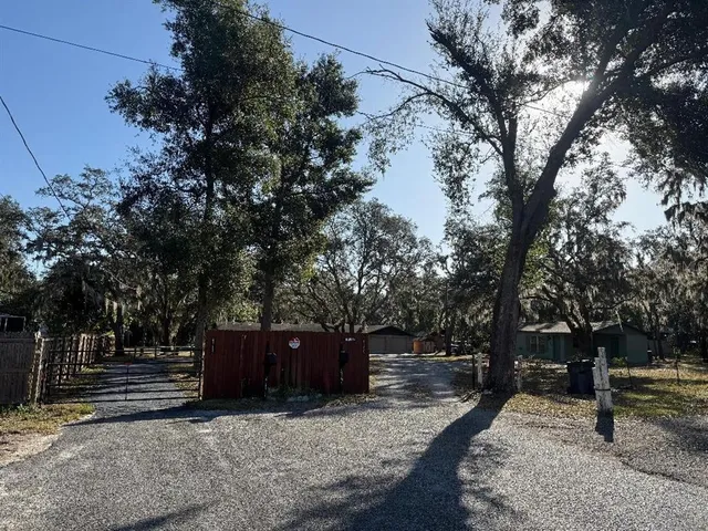 a view of a patio with table and chairs potted plants