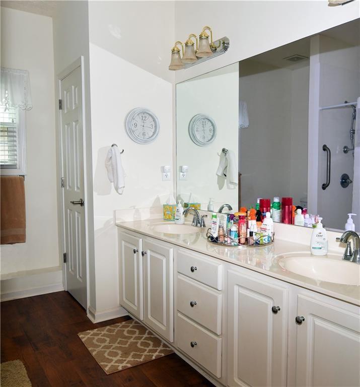 795 Sunset Ridge Lane Southeast Lawrenceville, GA 30045 - Photo 35 of 47 a bathroom with a sink mirror and vanity