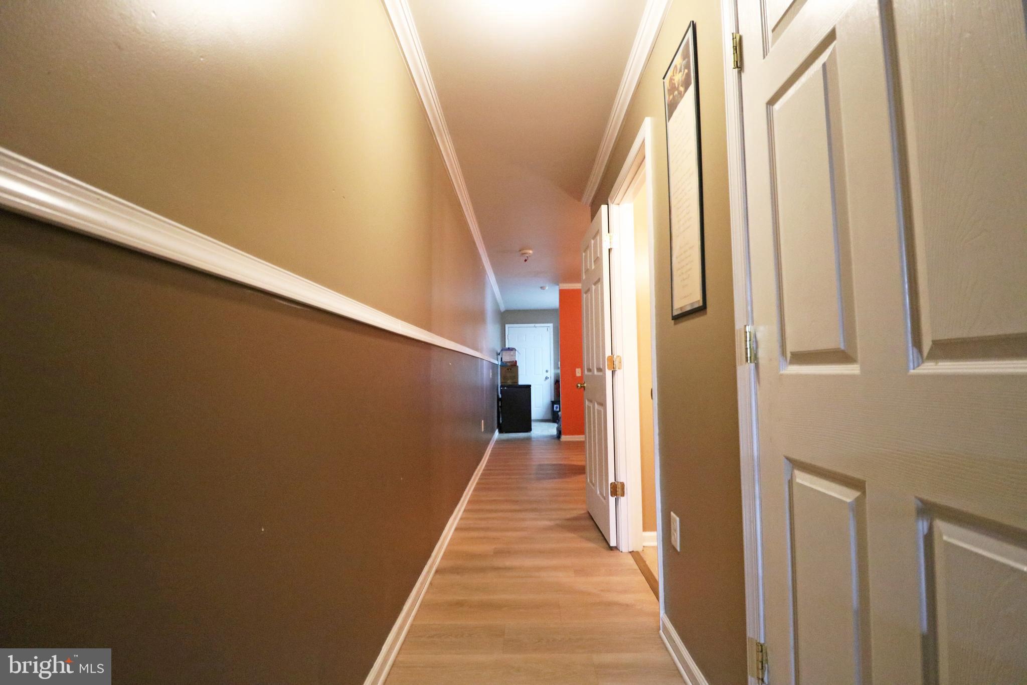 802 9th Street Chester, PA 19013 - Photo 17 of 43 a view of a hallway with wooden floor and stairs