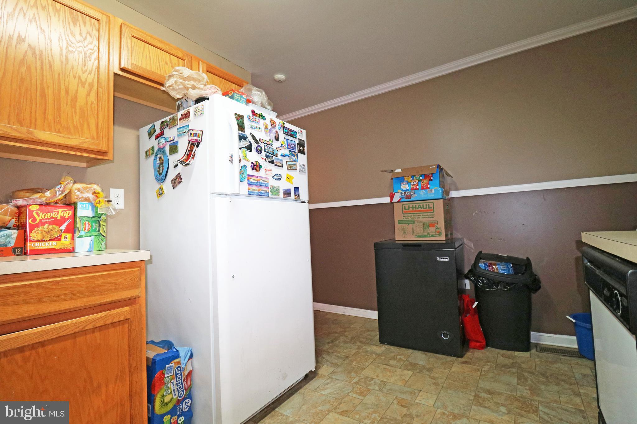 802 9th Street Chester, PA 19013 - Photo 25 of 43 a view of storage and utility room with fridge and workspace