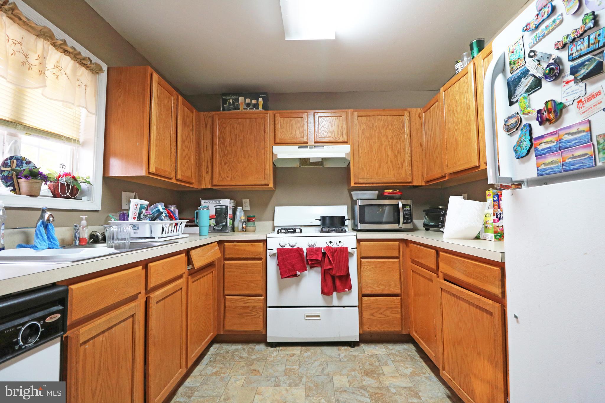 802 9th Street Chester, PA 19013 - Photo 26 of 43 a kitchen with stainless steel appliances a sink window and cabinets