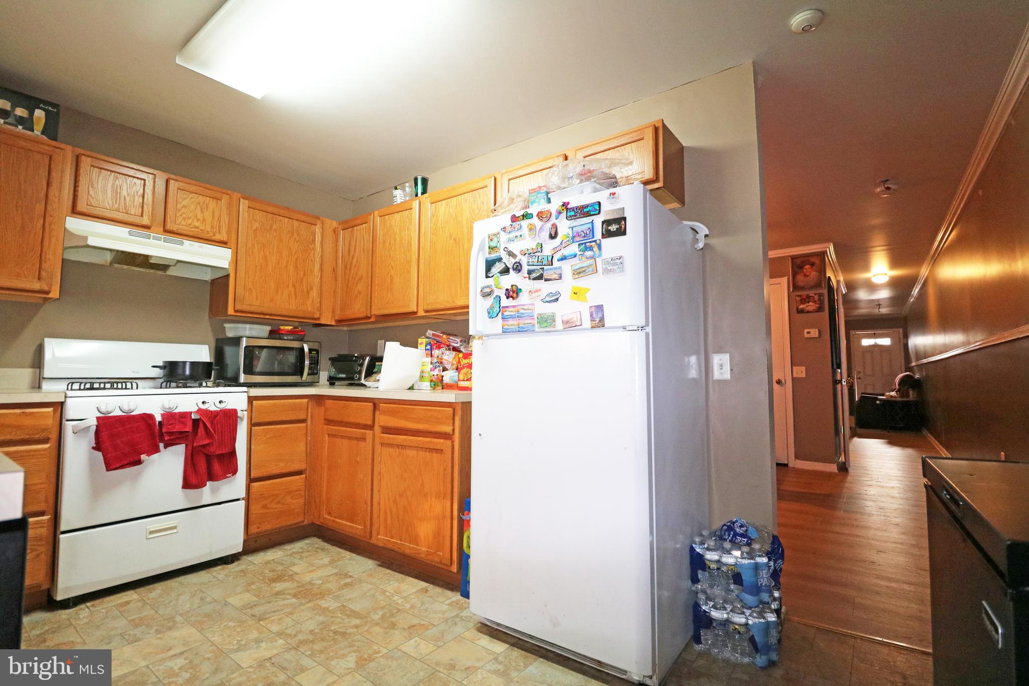 802 9th Street Chester, PA 19013 - Photo 27 of 43 a kitchen with stainless steel appliances granite countertop a refrigerator and a stove top oven
