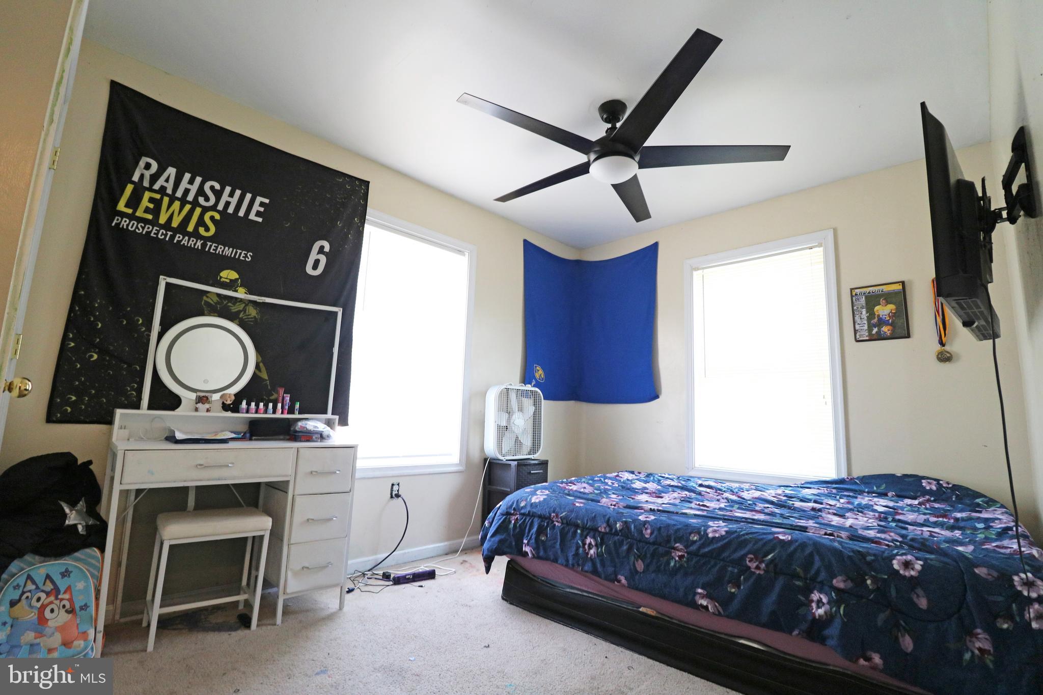 802 9th Street Chester, PA 19013 - Photo 33 of 43 a bedroom with a bed a chandelier and a fireplace