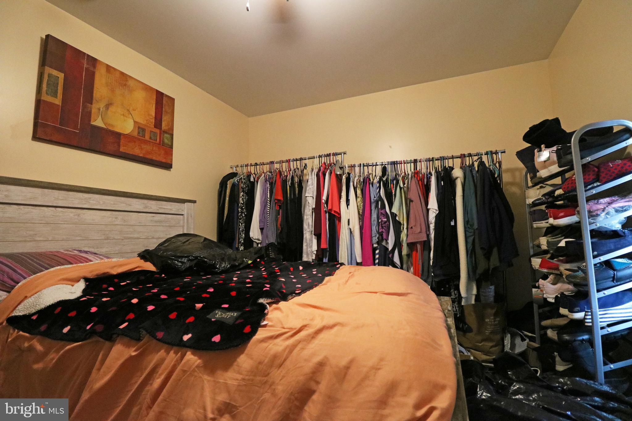 802 9th Street Chester, PA 19013 - Photo 35 of 43 a view of walk in closet with clothes and shoes