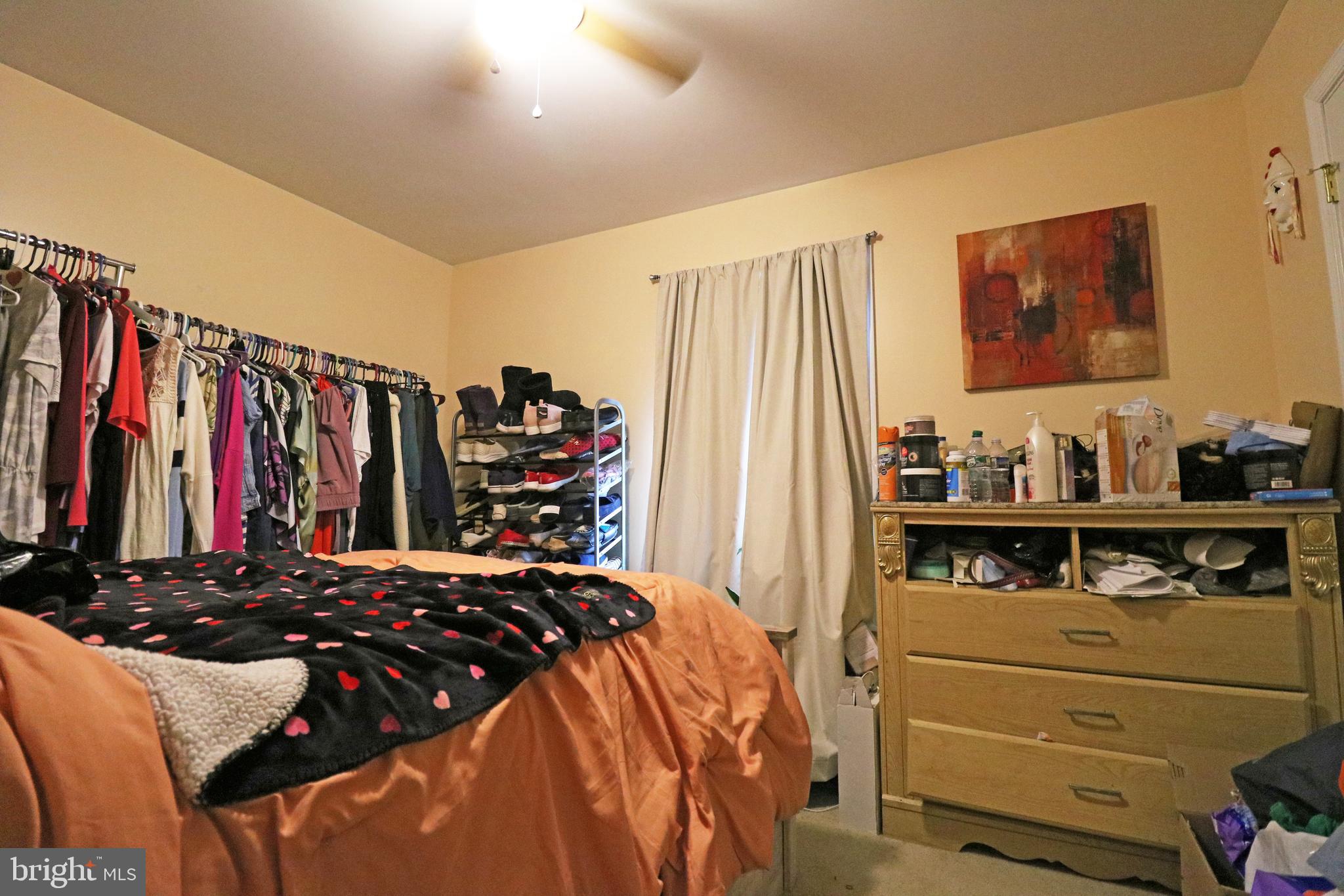 802 9th Street Chester, PA 19013 - Photo 36 of 43 a view of walk in closet with clothes and shoes