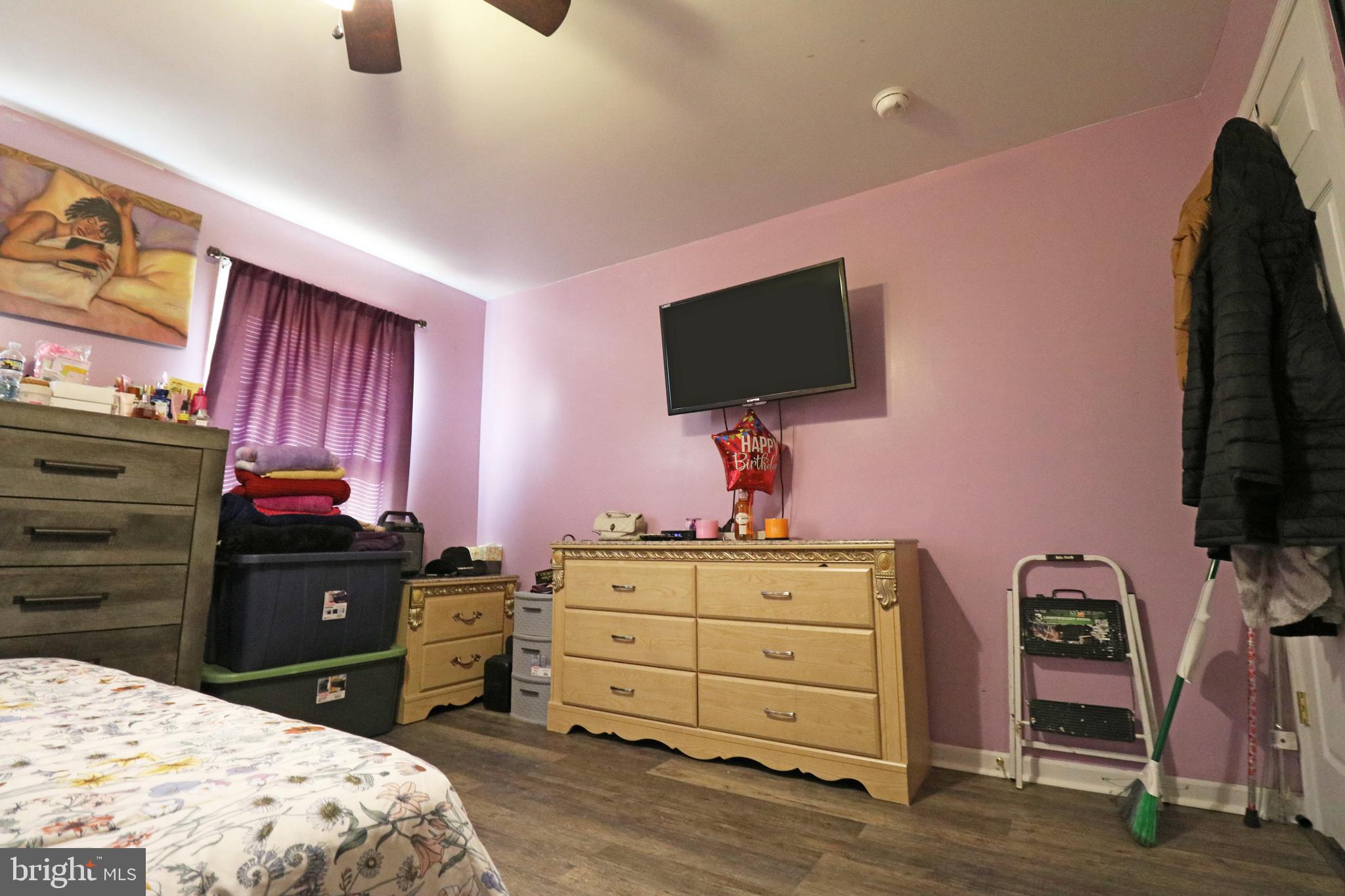 802 9th Street Chester, PA 19013 - Photo 40 of 43 a bedroom with a bed and a flat tv screen on dresser