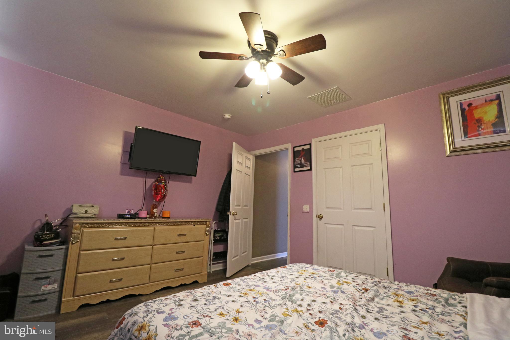 802 9th Street Chester, PA 19013 - Photo 41 of 43 a bedroom with a bed and a flat tv screen on dresser