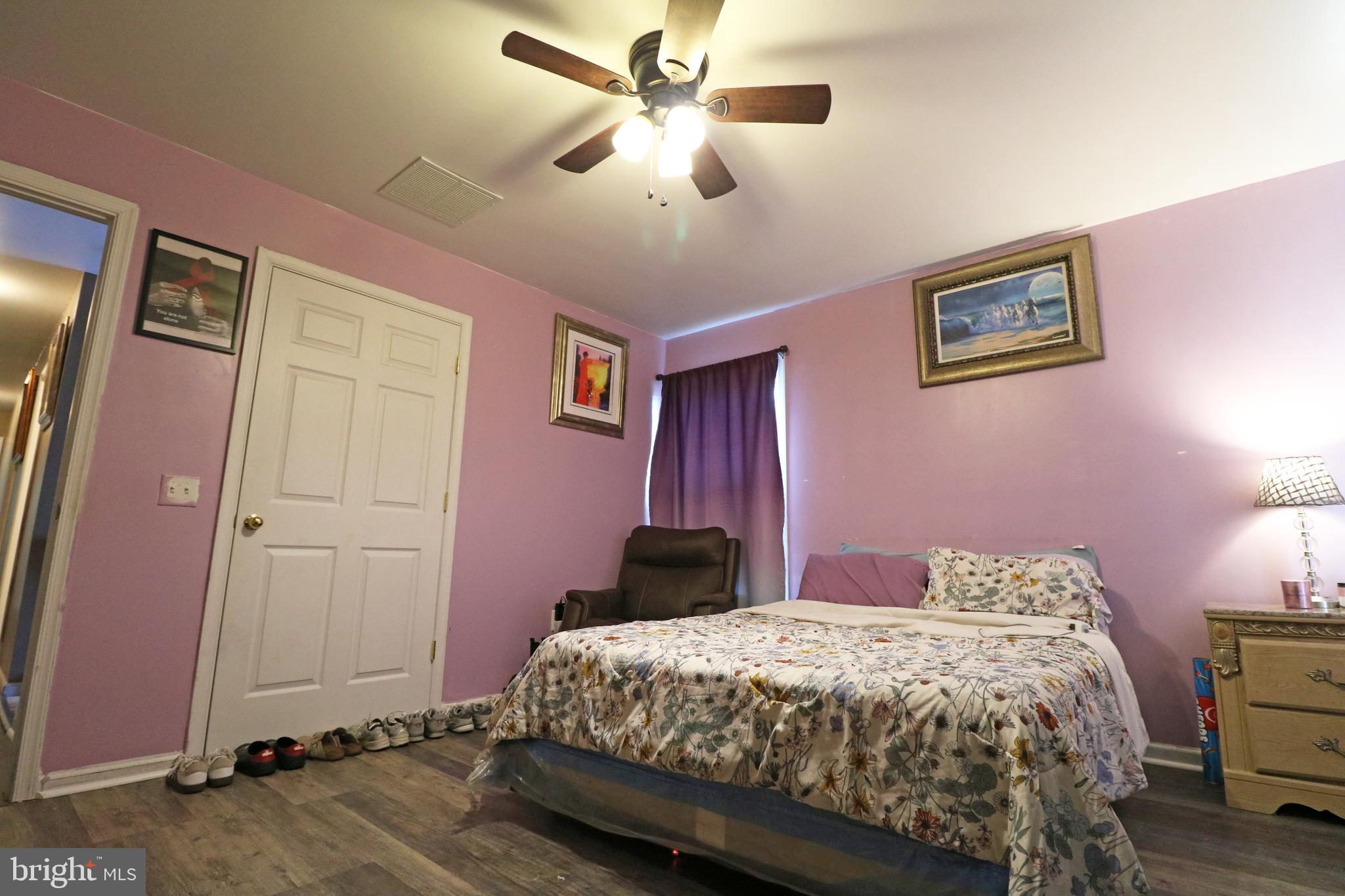 802 9th Street Chester, PA 19013 - Photo 42 of 43 a bedroom with a bed and a chandelier