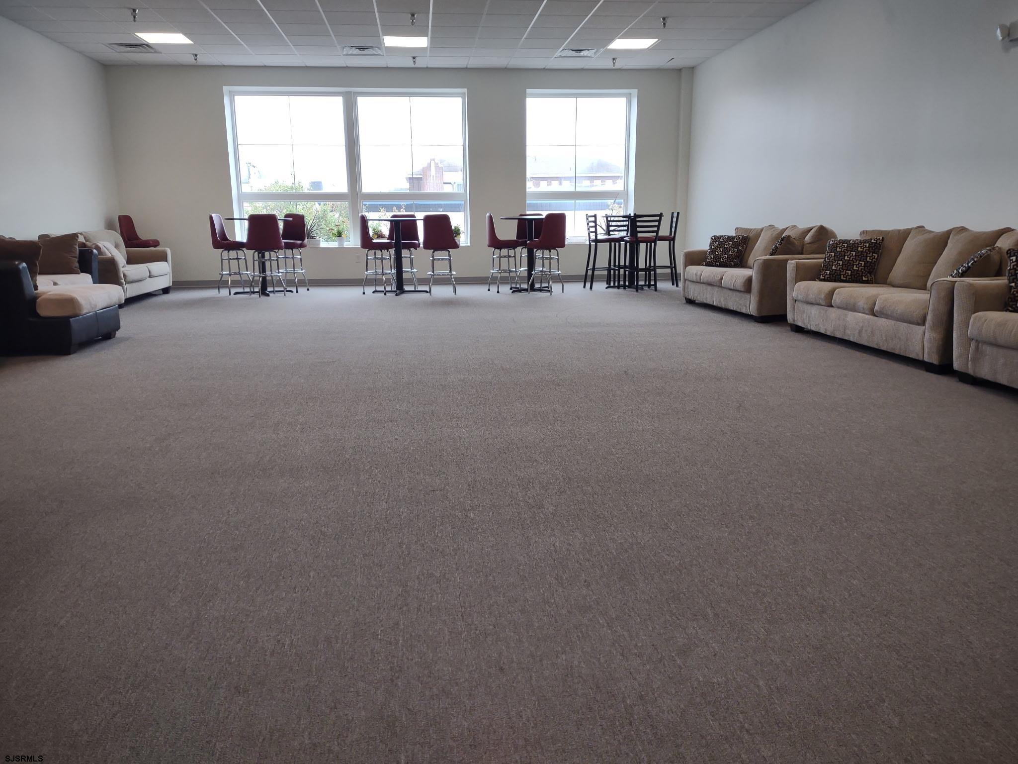 810 Asbury Avenue, Unit 303 Ocean City, NJ 08226 - Photo 14 of 20 a living room with furniture and a large window