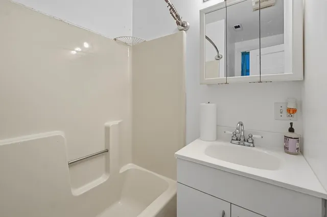 a bathroom with a sink and a shower