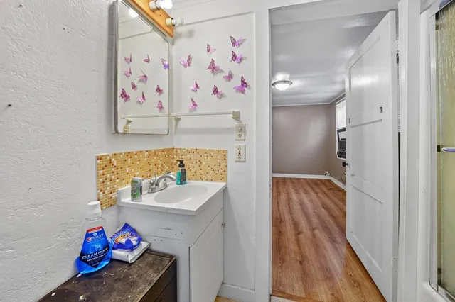 a view of bathroom with furniture and wooden floor