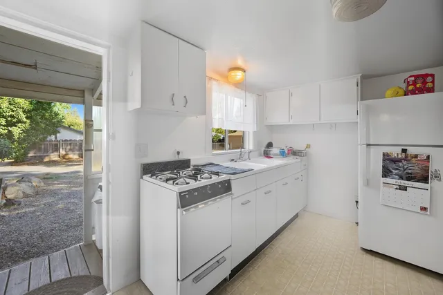 a kitchen with a stove a sink and a refrigerator