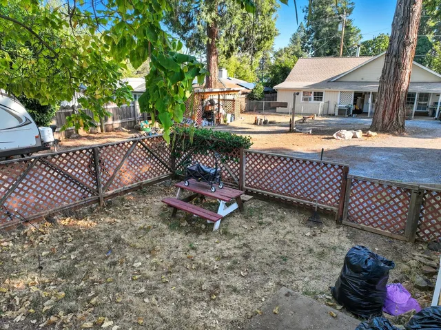 a view of a patio with couches table and chairs and potted plants