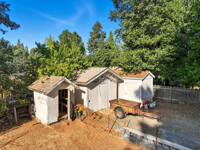 a view of a white house with a flat outdoor space and sitting area