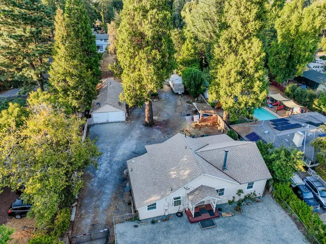 an aerial view of a house with a yard and garden