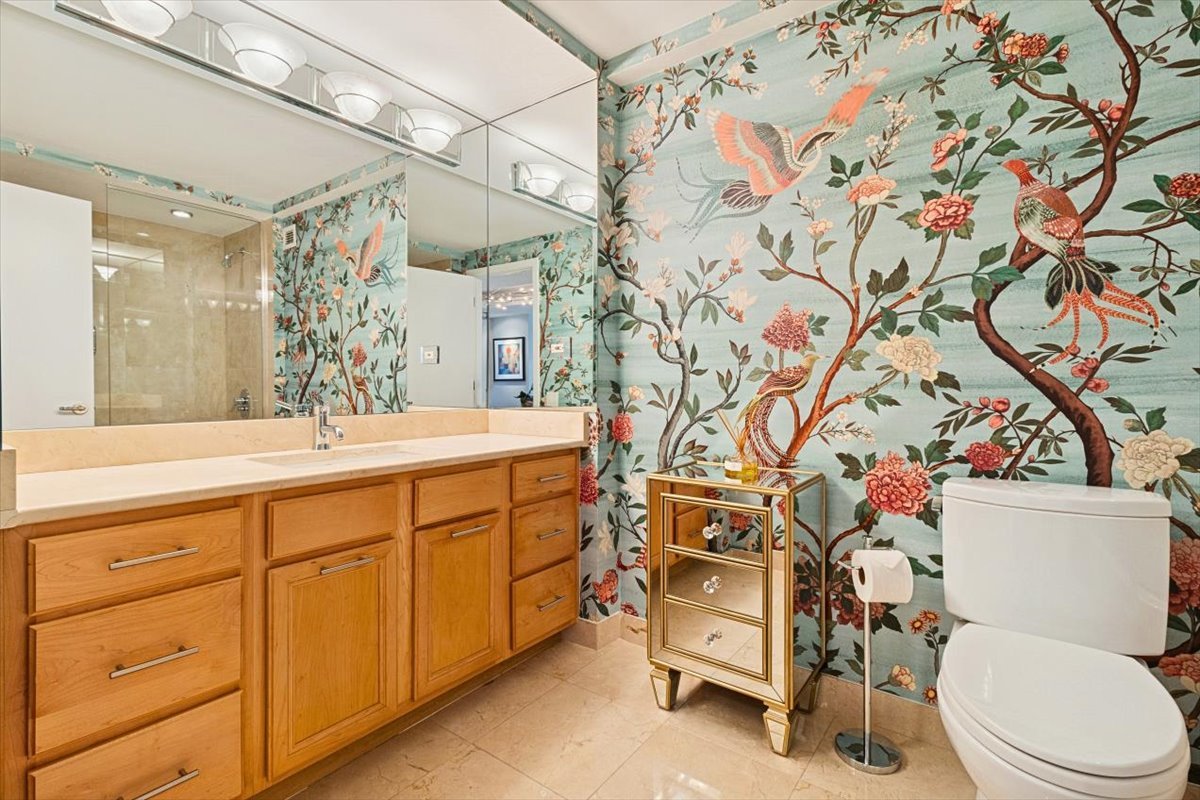 1030 North State Street, Unit 33GH Chicago, IL 60610 - Photo 11 of 26 a bathroom with a sink a toilet and a shower curtain