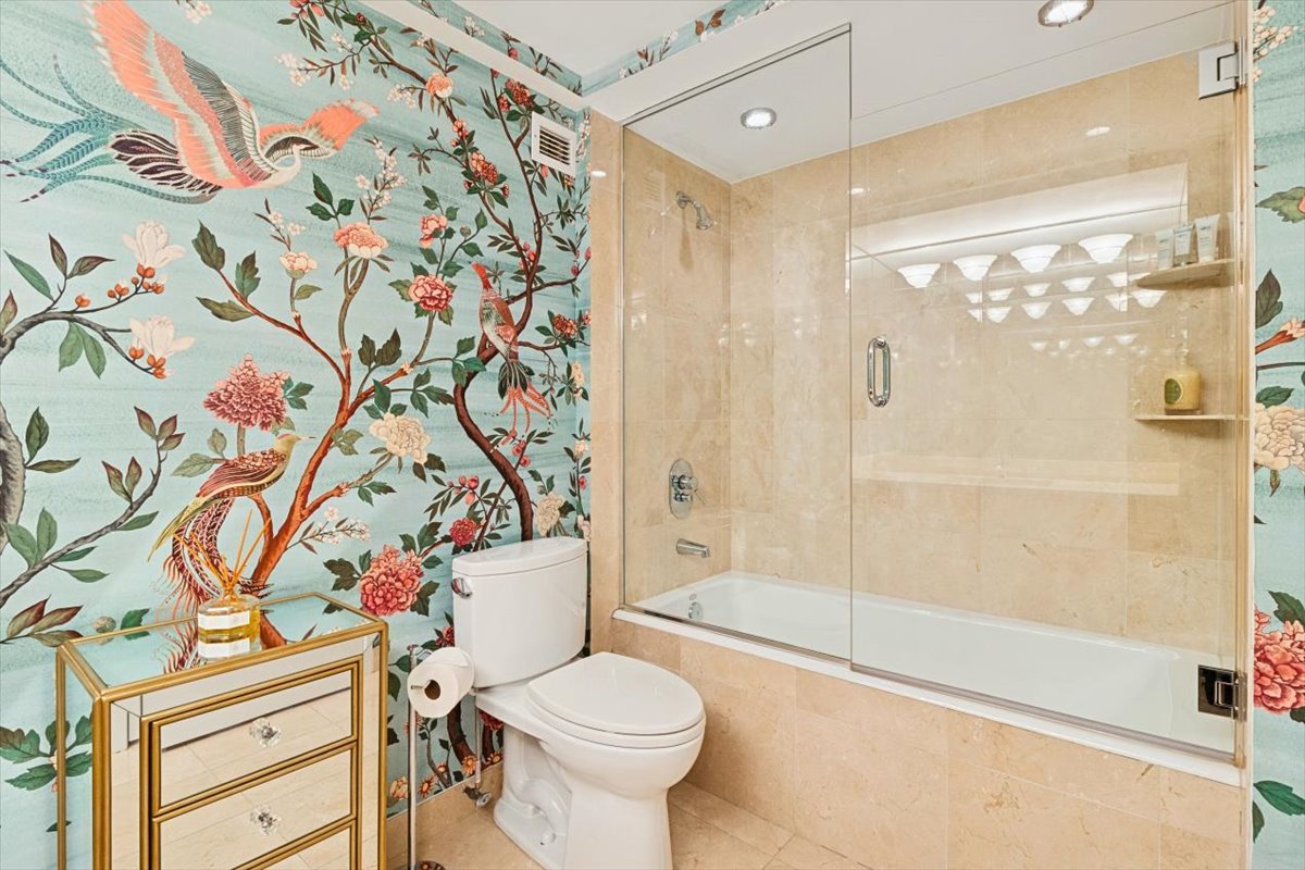 1030 North State Street, Unit 33GH Chicago, IL 60610 - Photo 12 of 26 a bathroom with a toilet and a shower curtain