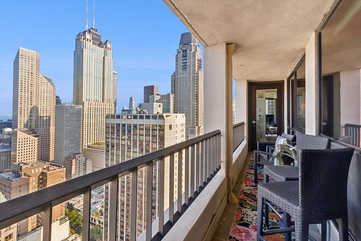 1030 North State Street, Unit 33GH Chicago, IL 60610 - Photo 19 of 26 a view of a balcony with chairs