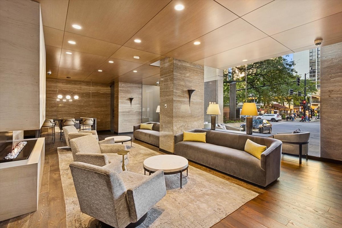 1030 North State Street, Unit 33GH Chicago, IL 60610 - Photo 2 of 26 a living room with furniture and a large window