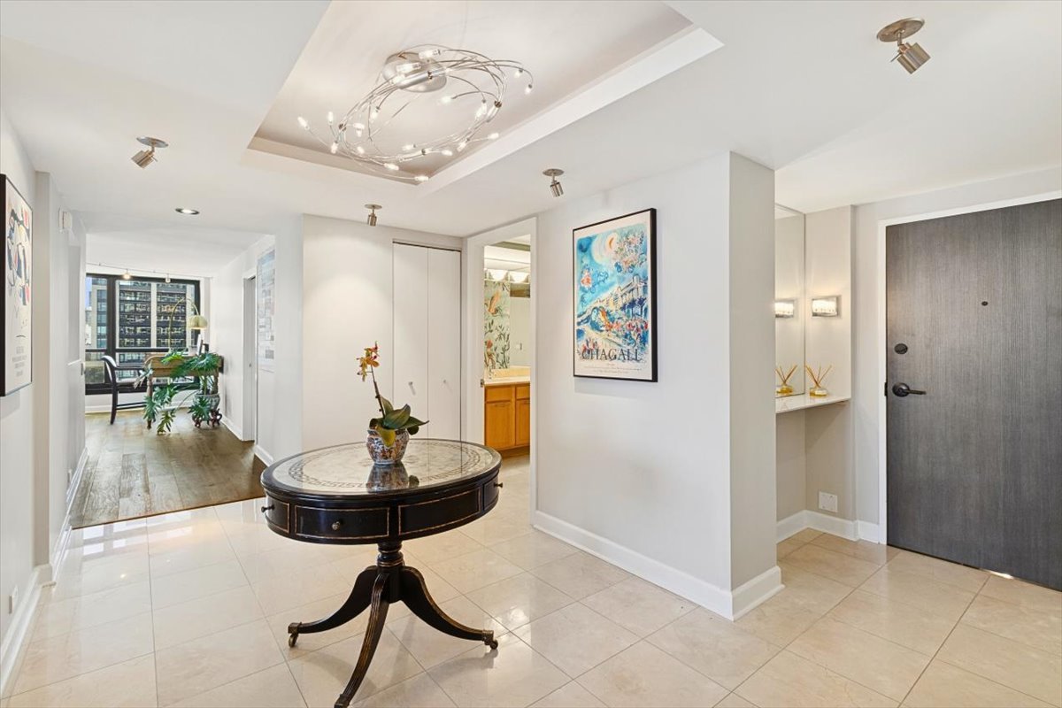 1030 North State Street, Unit 33GH Chicago, IL 60610 - Photo 3 of 26 a view of a room with furniture and wooden floor