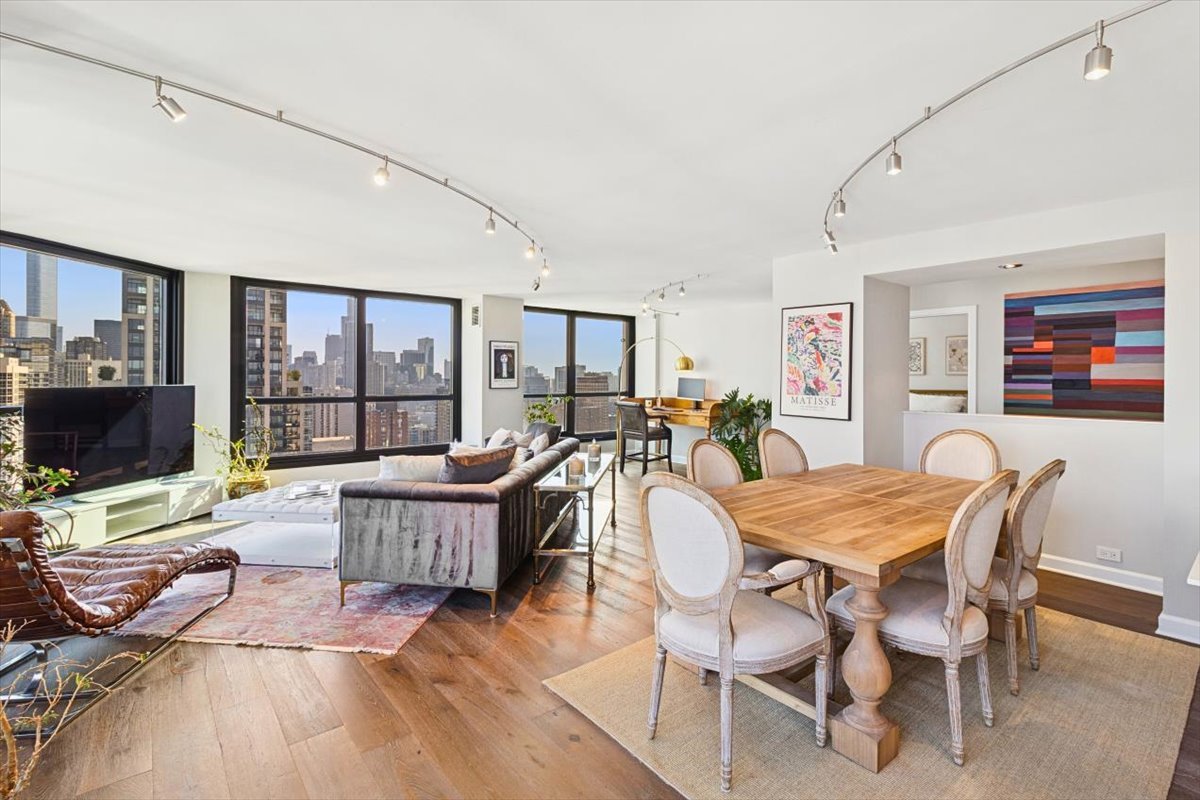 1030 North State Street, Unit 33GH Chicago, IL 60610 - Photo 5 of 26 a living room with furniture a flat screen tv and a large window