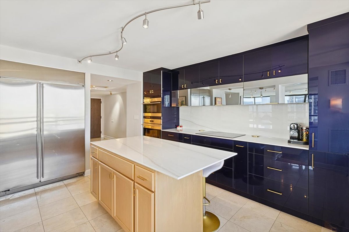 1030 North State Street, Unit 33GH Chicago, IL 60610 - Photo 8 of 26 a kitchen with a sink a refrigerator and cabinets