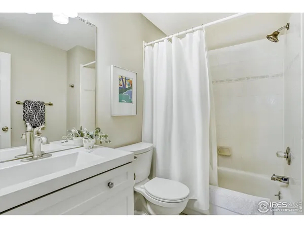 a bathroom with a sink toilet a mirror a bathtub and shower
