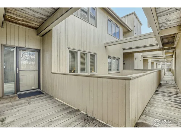 a view of a house with a wooden deck