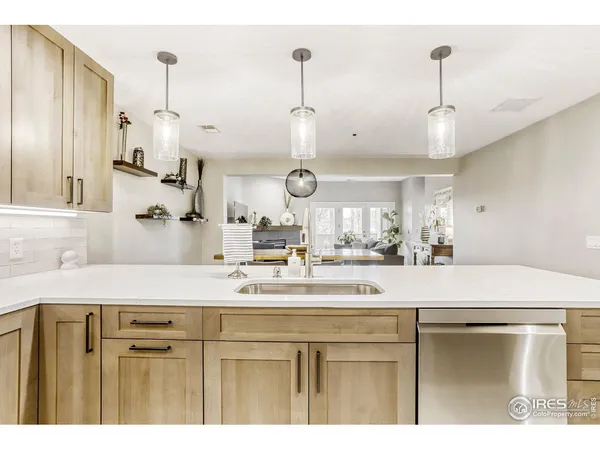 a kitchen with a sink a refrigerator and cabinets