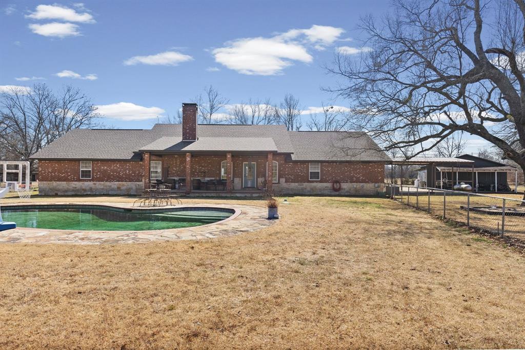 24 County Rd NW 1060 Talco, TX 75487 - Photo 30 of 40 a view of a house with swimming pool and a yard