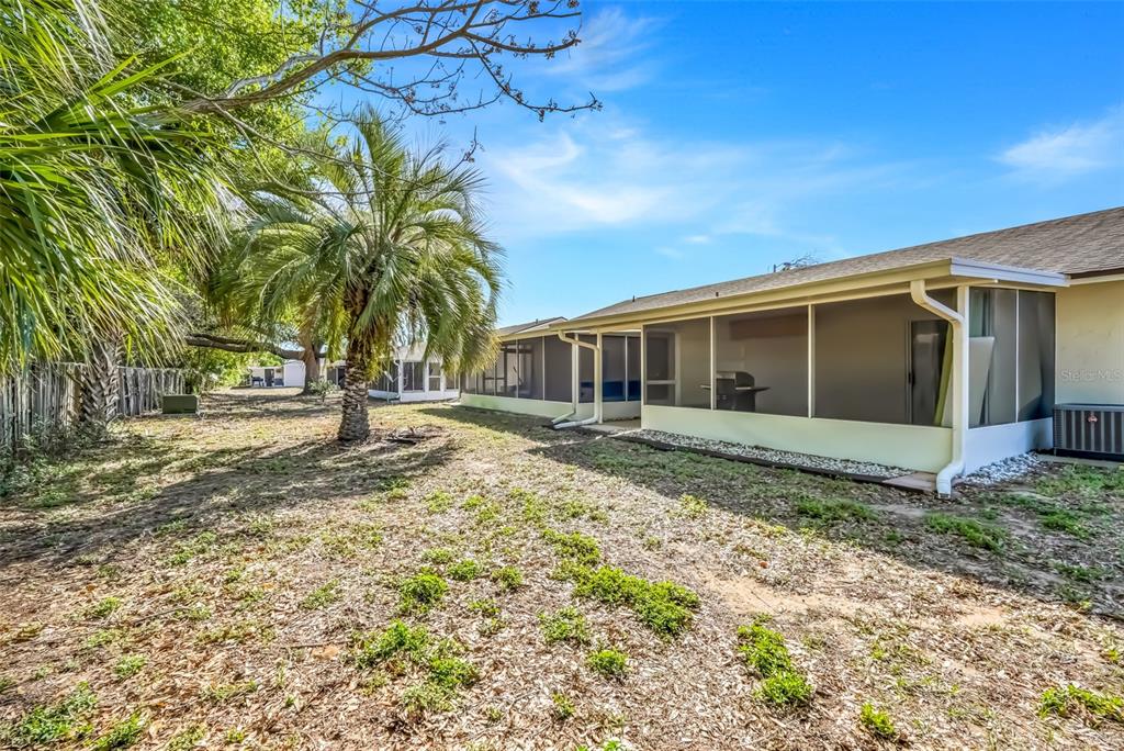 30024 Tavares Ridge Boulevard, Unit 62 Tavares, FL 32778 - Photo 28 of 31 a view of a house with a yard
