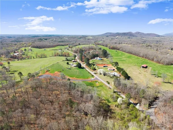 an aerial view of a house with outdoor space and a lake view