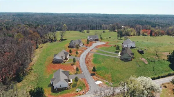 an aerial view of a house with a yard basket ball court