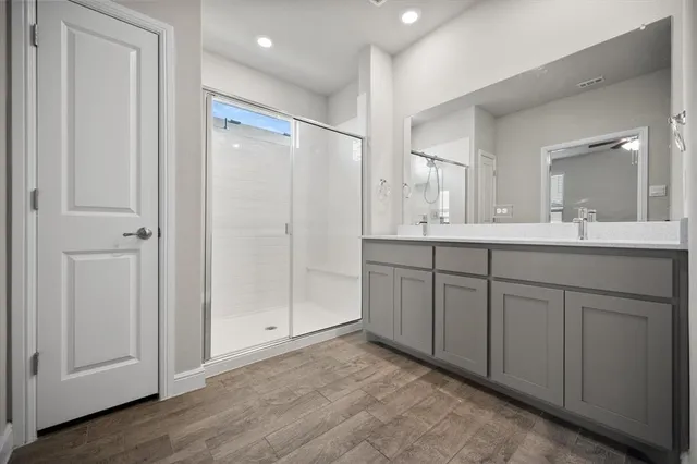 a bathroom with a double vanity sink and mirror