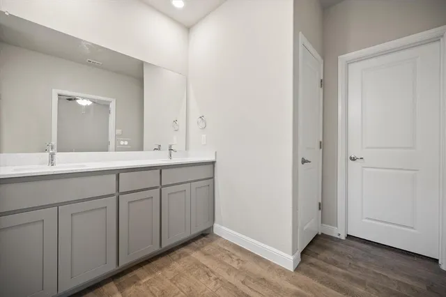 a bathroom with a double vanity sink and a mirror