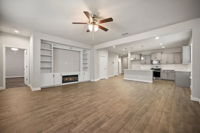 a view of an empty room with a kitchen