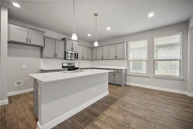 a kitchen with a stove a sink and a refrigerator