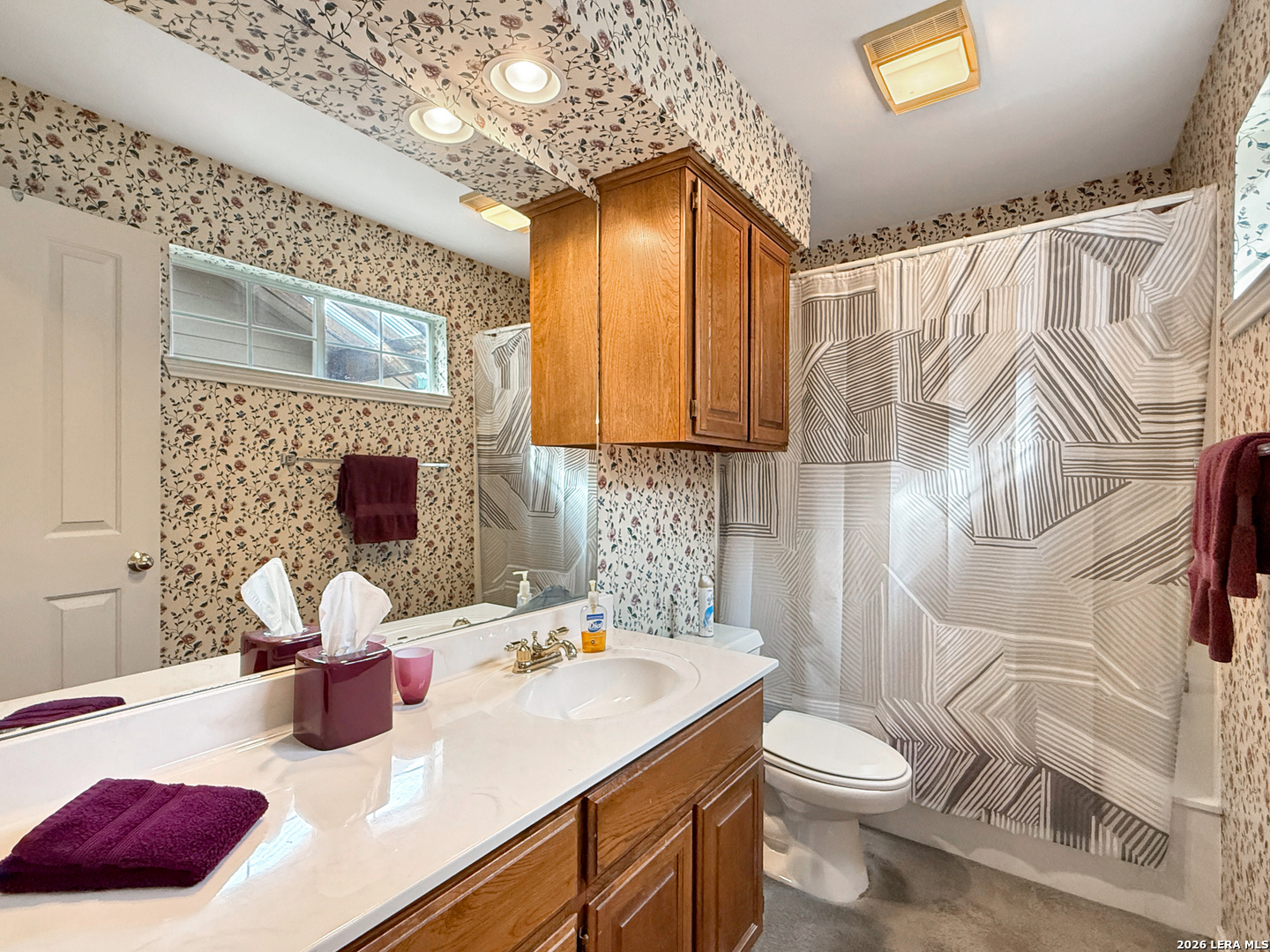 140 St Andrews Loop Kerrville, TX 78028 - Photo 16 of 24 a bathroom with a sink a toilet and shower curtain
