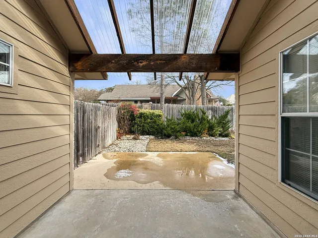 a view of a backyard with large trees