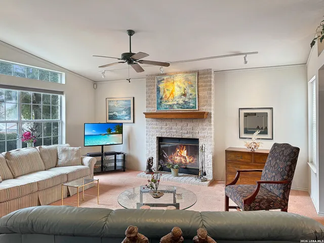 a view of a dining room with furniture a chandelier and wooden floor