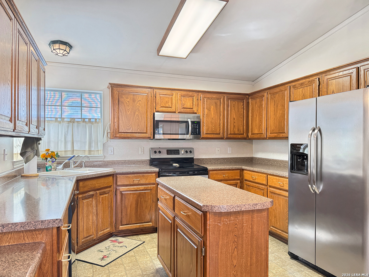 140 St Andrews Loop Kerrville, TX 78028 - Photo 7 of 24 a kitchen with a refrigerator sink and cabinets