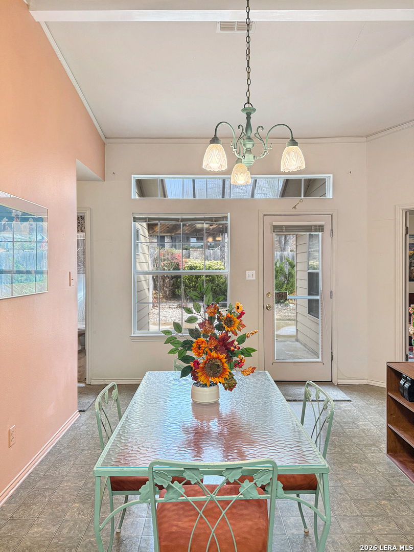 140 St Andrews Loop Kerrville, TX 78028 - Photo 8 of 24 a view of a dining room with furniture a chandelier and wooden floor