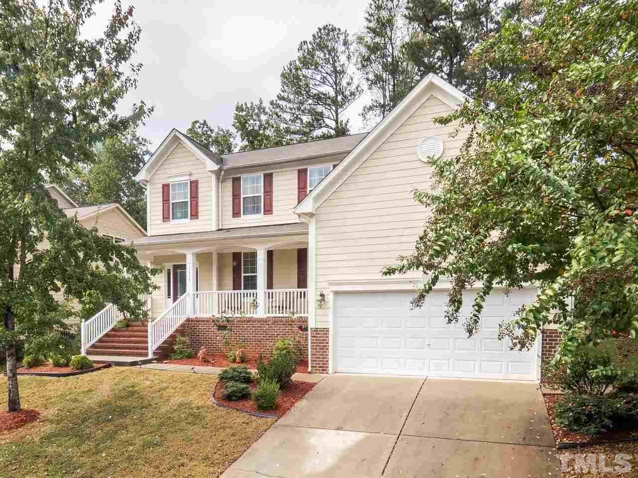 3016 Red Grape Drive Raleigh, NC 27607 - Photo 2 of 23 a view of a white house with large windows and a small yard