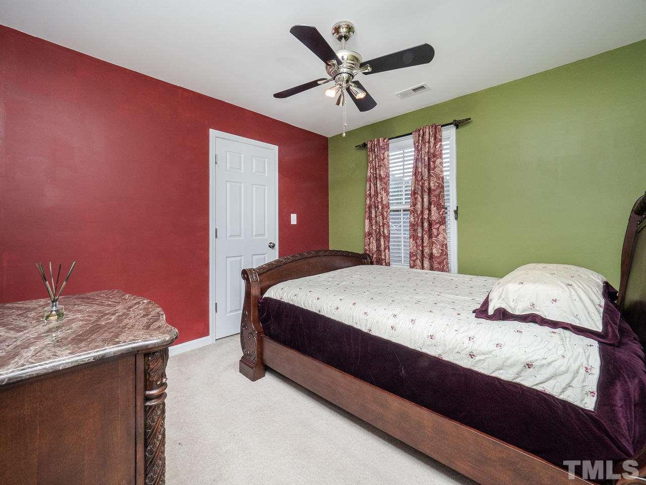 3016 Red Grape Drive Raleigh, NC 27607 - Photo 15 of 23 a bedroom with a bed and a chandelier
