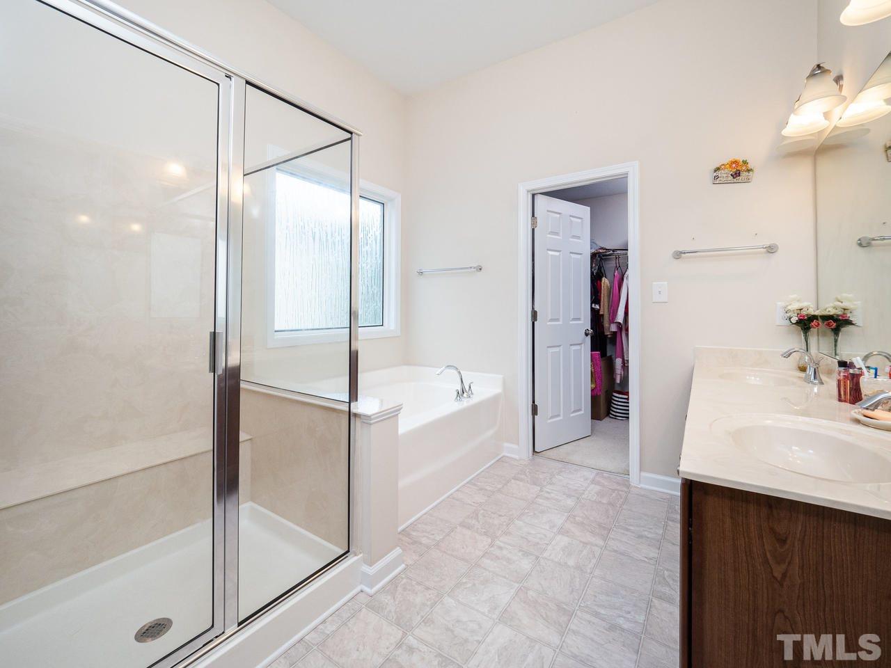 3016 Red Grape Drive Raleigh, NC 27607 - Photo 19 of 23 a bathroom with a bathtub and a sink
