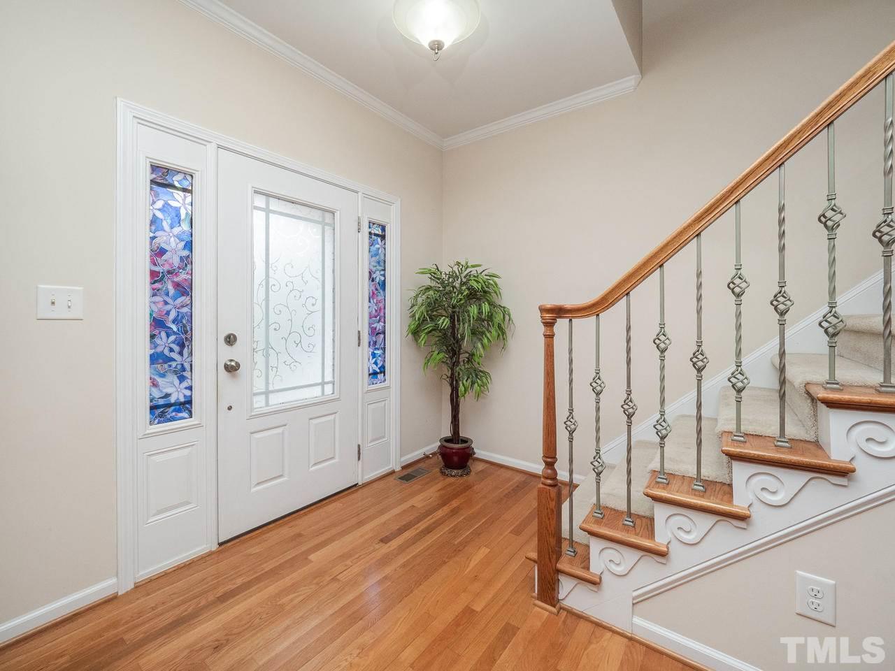 3016 Red Grape Drive Raleigh, NC 27607 - Photo 4 of 23 a view of a room with wooden floor and stairs