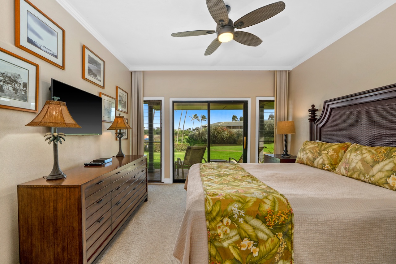 1565 Pe'e Road, Unit 211 Koloa, HI 96756 - Photo 14 of 30 a bedroom with furniture and a flat screen tv