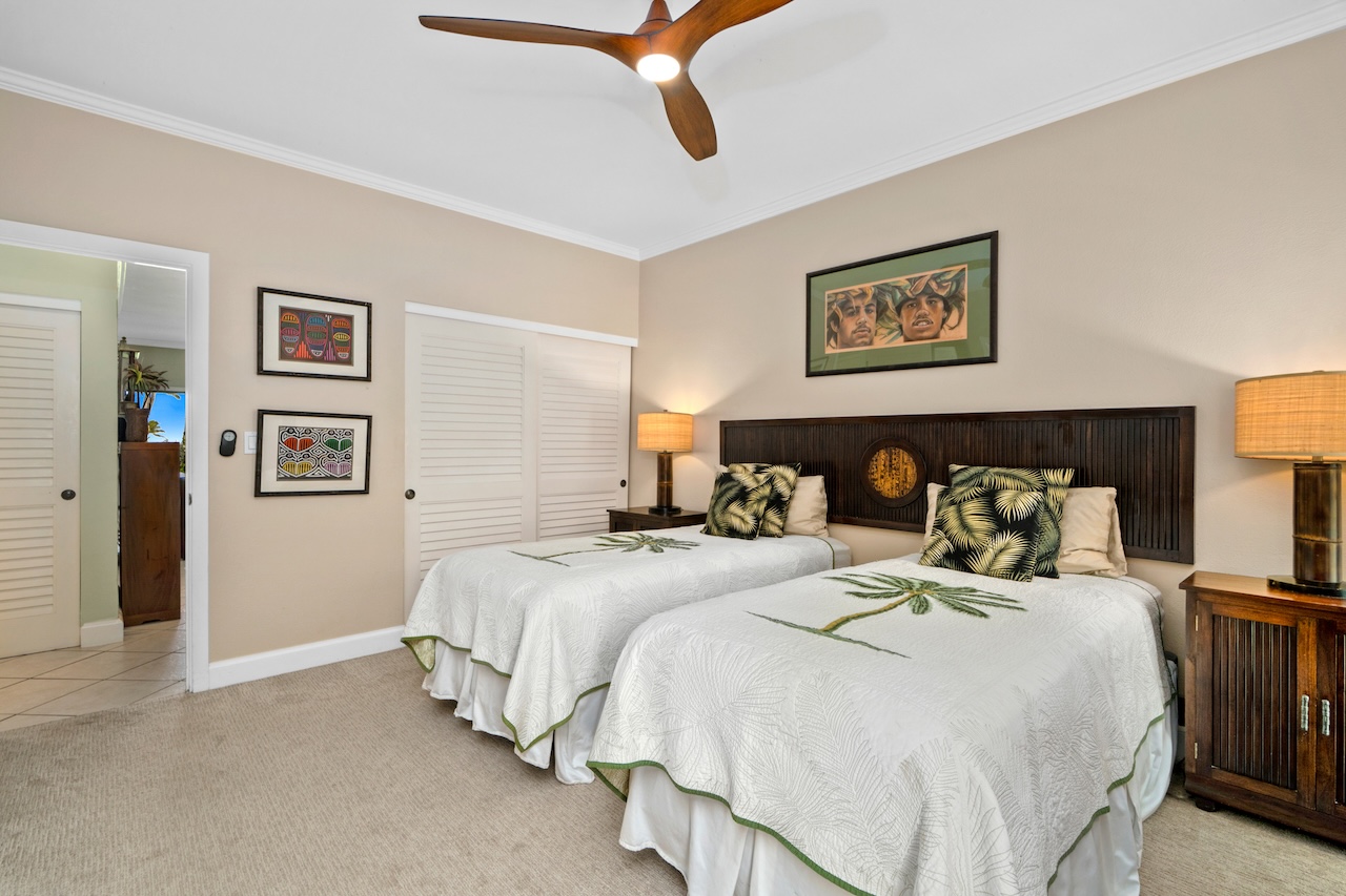 1565 Pe'e Road, Unit 211 Koloa, HI 96756 - Photo 18 of 30 a bedroom with a bed and lamp